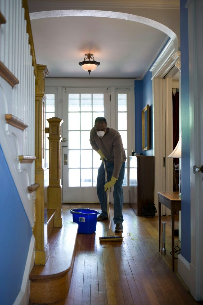 zipwp-image-jjrxvzbqc5e This African-American man was in the process of damp-mopping his home’s entrance way. In this way airborne particulates including dust and pollen, could be removed from the inside of his home, thereby, reducing the detrimental effects these substances have upon the respiratory system of his family members. These irritants can sometimes result in sinus infections, and asthma.